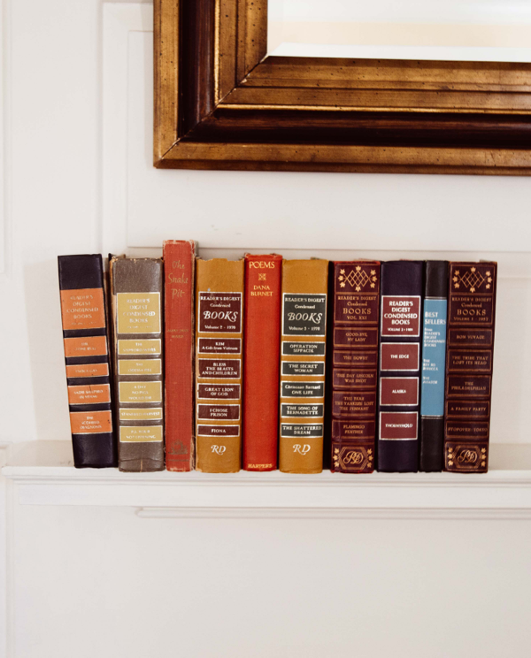 Stacked books on the fireplace mantel inside Campbell House